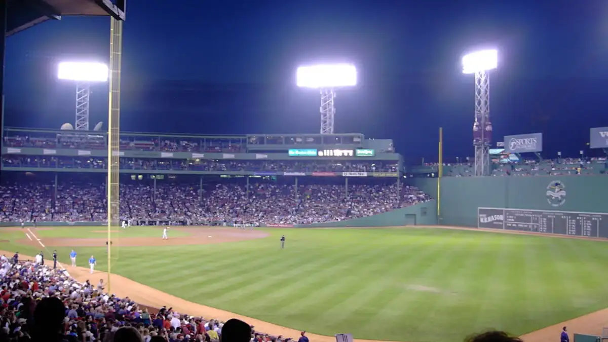 Baseball stadium under bright lights during an evening game