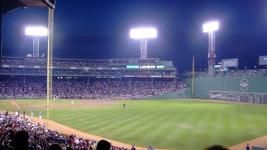 Baseball stadium under bright lights during an evening game