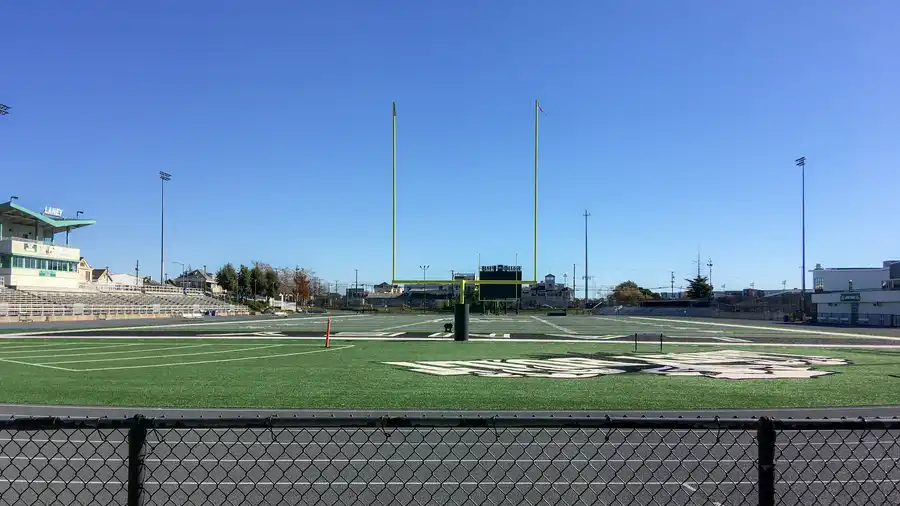 American football field with yard lines and bleachers