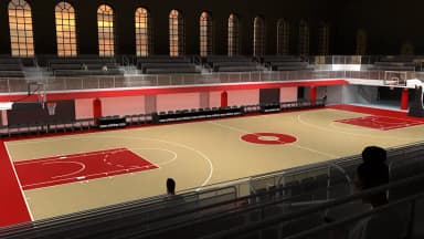 Indoor basketball arena with court and seating visible